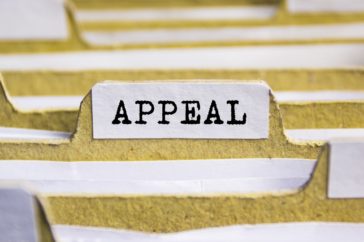 Filing cabinet containing files, with one file labelled with 'appeal'