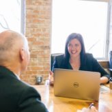 A woman and a man in an interview laughing