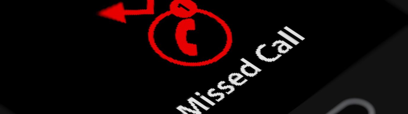 A mobile phone with the words 'missed call' on the screen