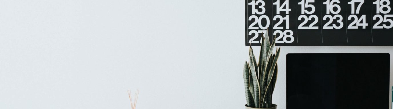 Empty desk with Mac and calendar sat on top