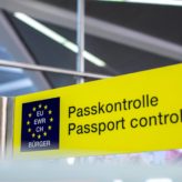 A yellow EU passport Control sign at an airport
