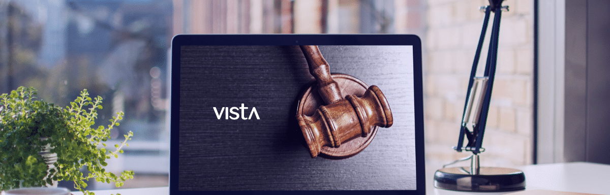 A laptop on an employees desk with a Judges gavel image on the screen