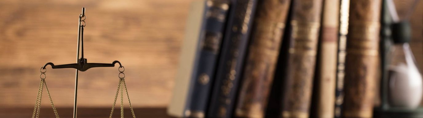 Legal scales and a stack of legal books