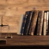 Legal scales and a stack of legal books
