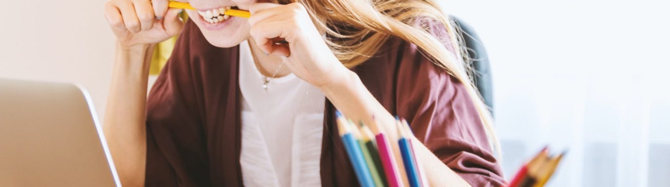 A female HR professional looking frustrated at her laptop