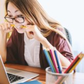 A female HR professional looking frustrated at her laptop