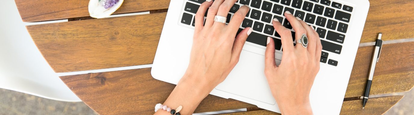 A female typing on a laptop
