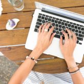 A female typing on a laptop